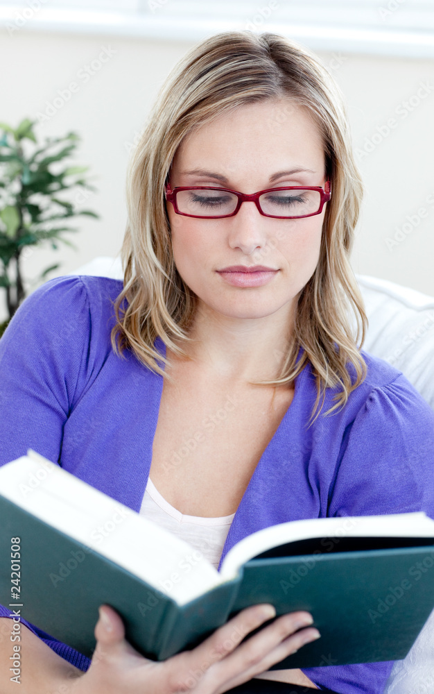 Young woman with glasses reading a book Young woman with glasses reading a book