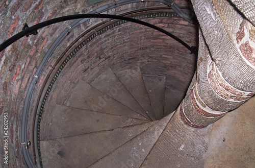 vintage spiral staircase, textured stone construction photo