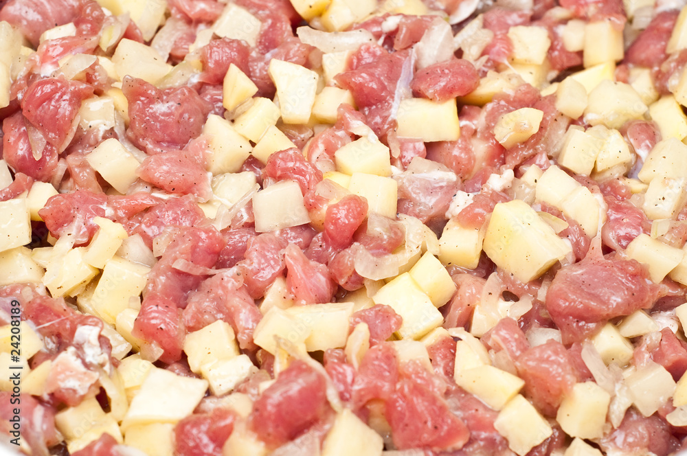 closeup of raw diced meat and potatoes ready to be cooked closeup of raw diced meat and potatoes ready to be cooked