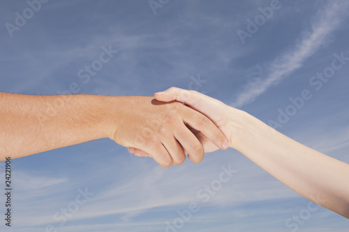 Handshake aginst blue sky