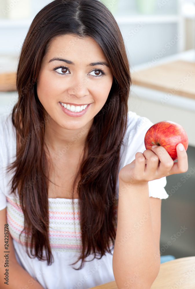 Attractive woman eating an apple in kitchen Attractive woman eating an apple in kitchen