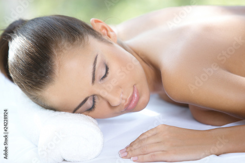 Beautiful woman is resting on spa bed