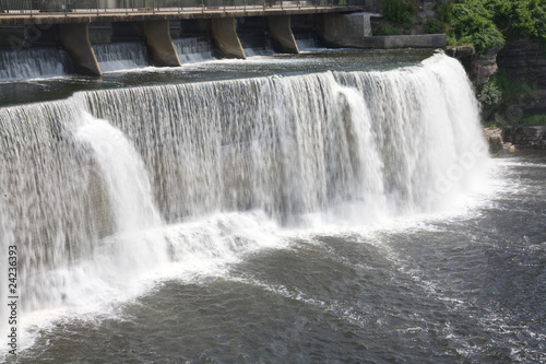 Full length view of the water pouring over edge of waterfall