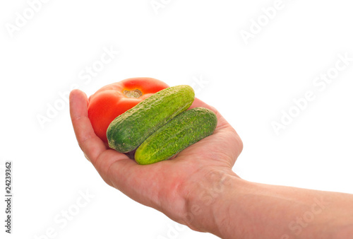 well shaped hand with fresh  vegetables isolated over white