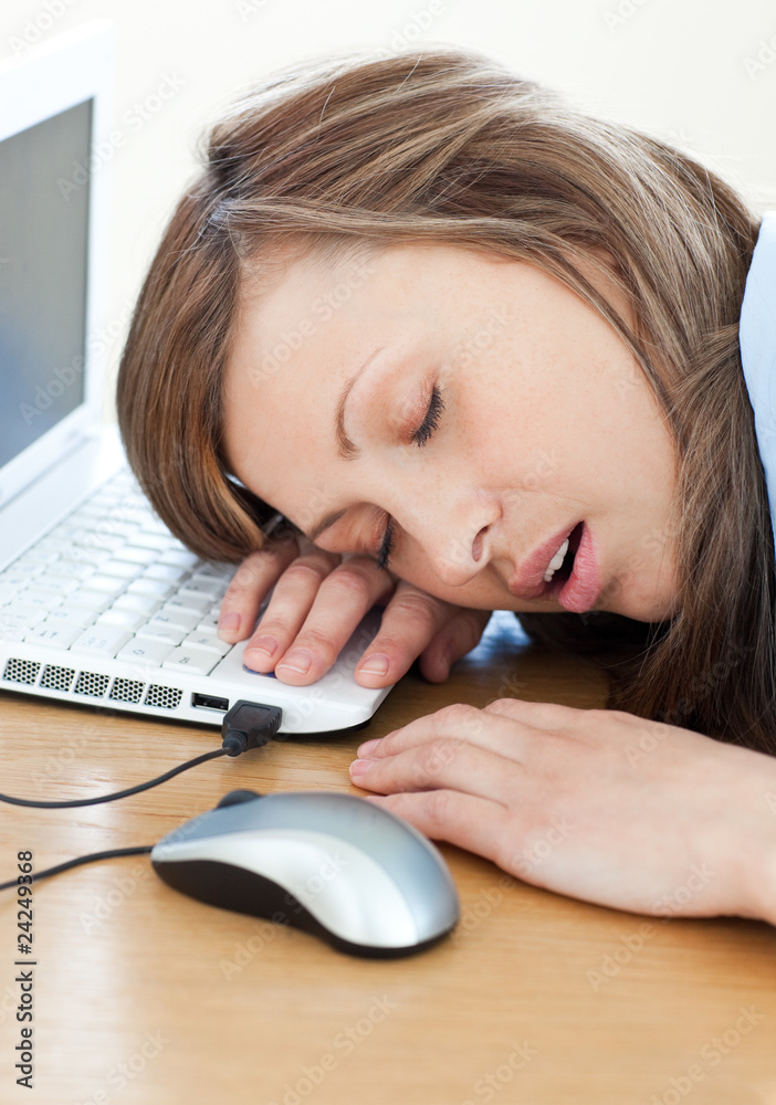 Young businesswoman sleeping on the keyboard Young businesswoman sleeping on the keyboard