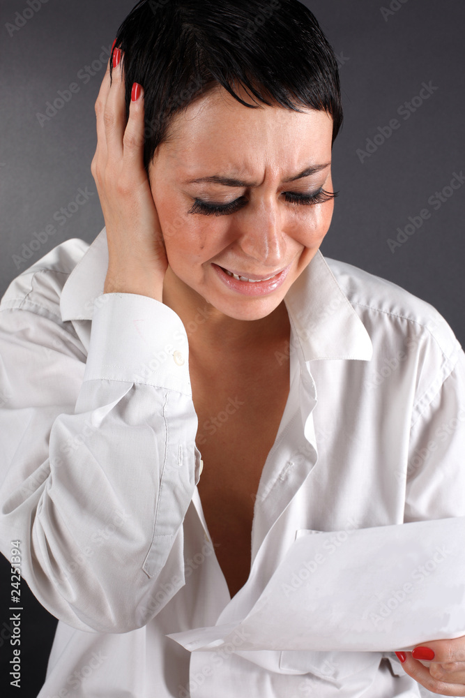 bad news - depression woman with tears holding letter