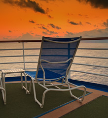Fototapete Karibik Empty Lounge Chair with view of Sunset on Caribbean  © Ruth P. Peterkin