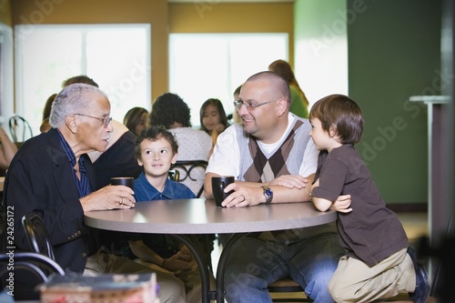 Grandfather, Father And Grandsons Visiting Together