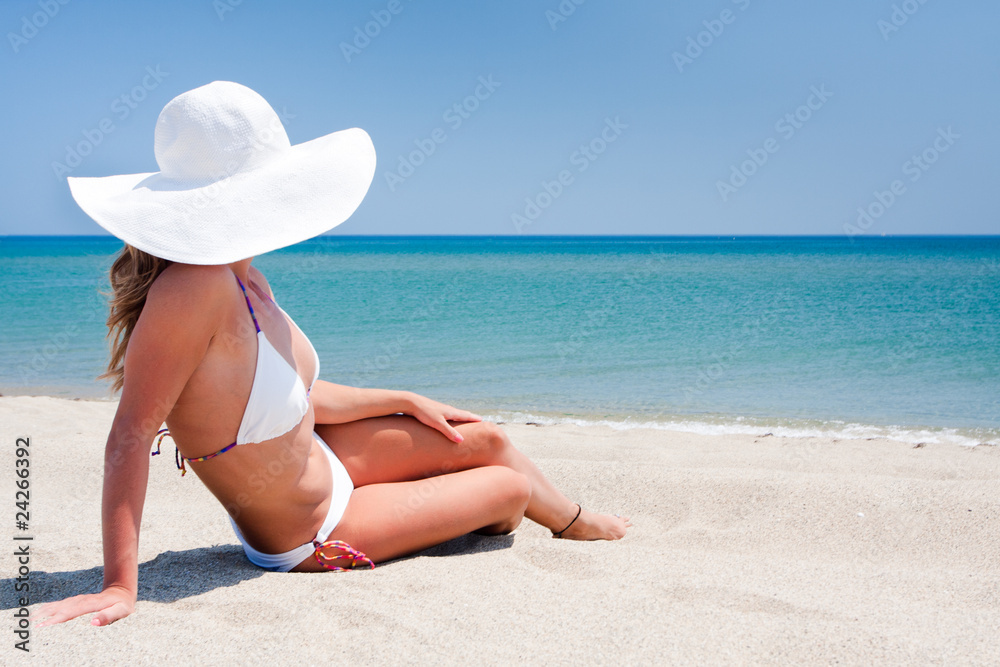 Young woman enjoying the sun on a beach