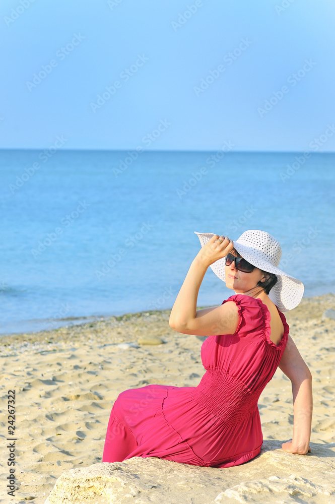 Portrait of beautiful female in red dress on beach Portrait of beautiful female in red dress on beach