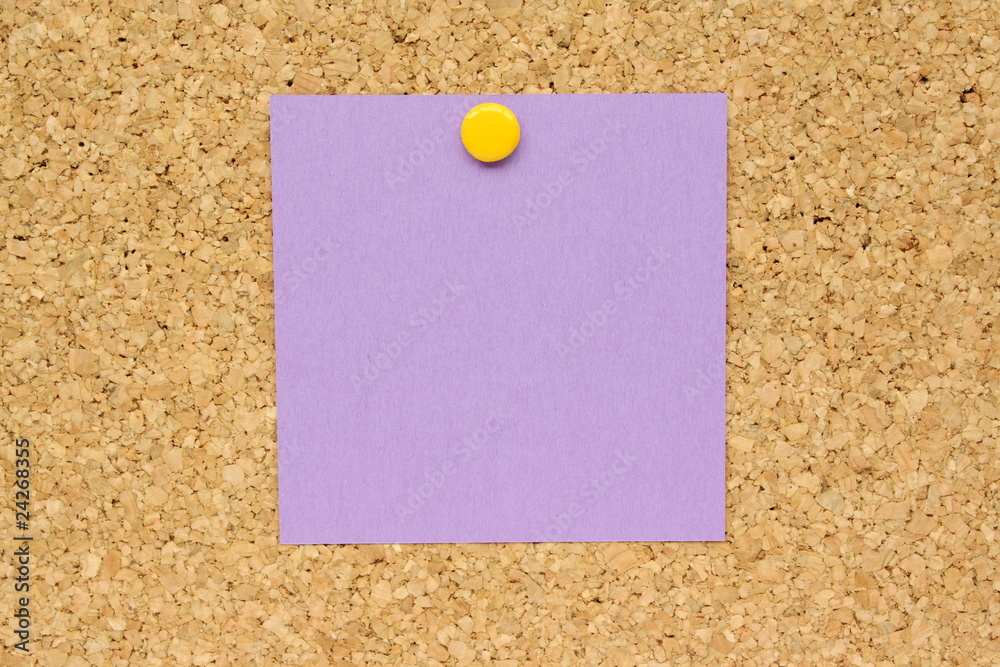 Purple Post it Note pinned to a cork board Purple Post it Note pinned to a cork board