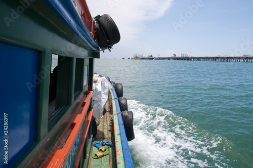 Old, wooden supply boat in Thailand.