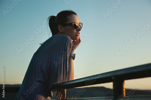 Nostalgic young beauty wearing sunglasses