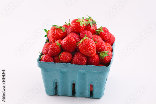 Fresh isolated strawberries in a pint