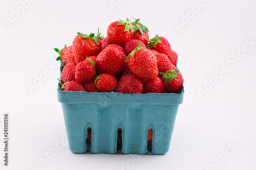 Fresh isolated red strawberries in a pint
