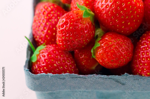 Fresh isolated strawberries in a pint