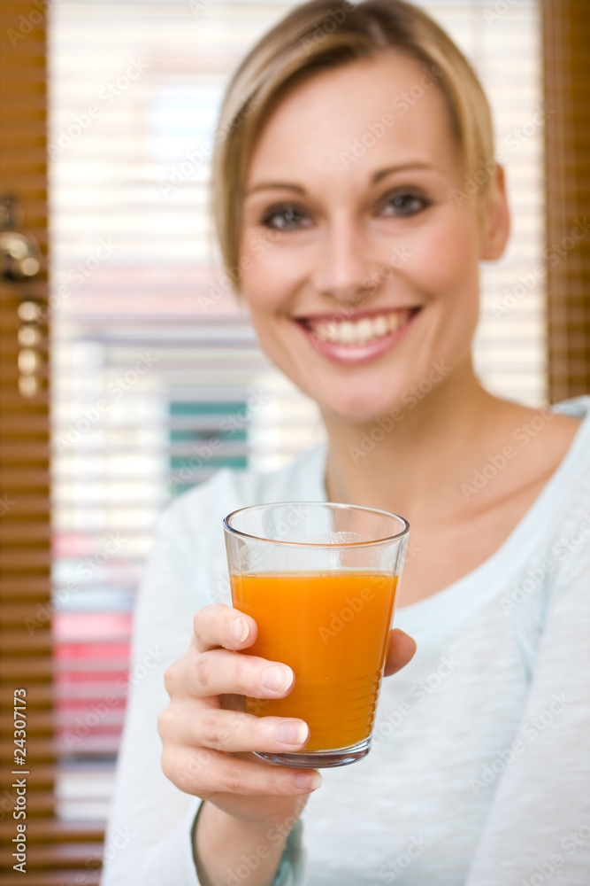 Beautiful young woman holding glass of orange juice Beautiful young woman holding glass of orange juice
