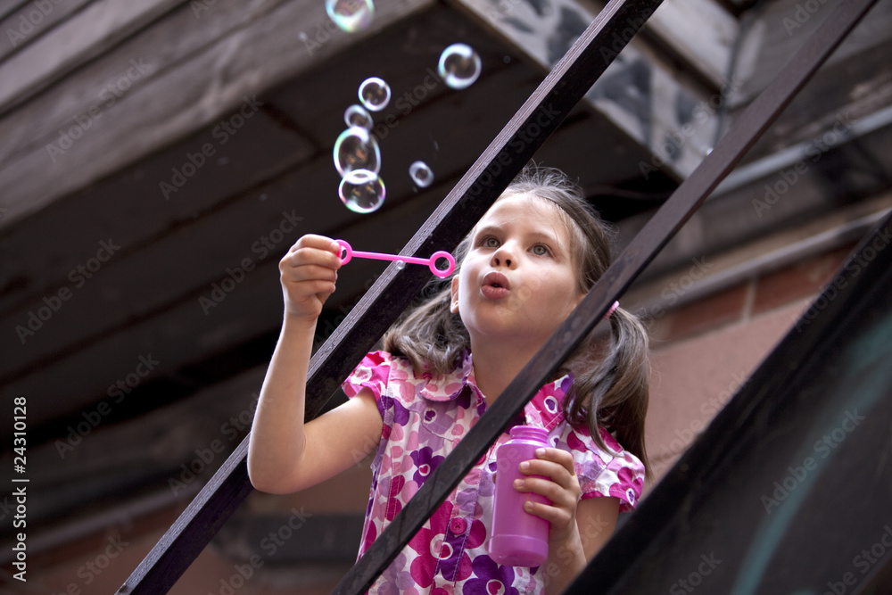 girl blowing bubbles