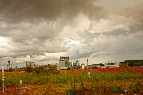 Oil rafinery against stormy clouds