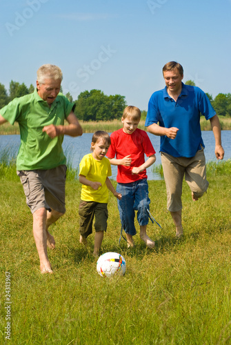 happy family playing soccer