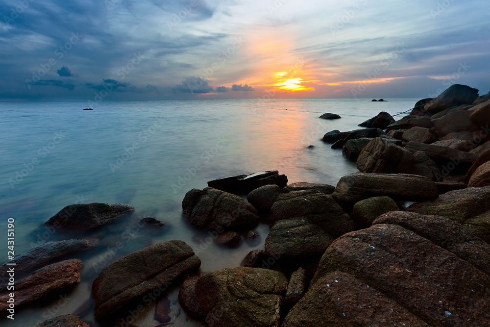 Tropical sunset on the stones beach. Thailand