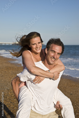 Young Attractive Couple Playing on Beach