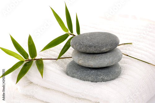 Laying down bamboo and stones on towel