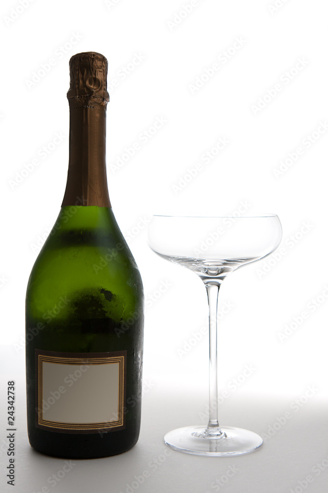 Champagne Bottle Next to an Empty Glass