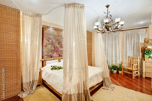 Medieval style bedroom with canopy bed on wide angle view