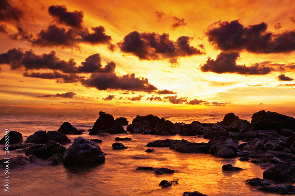 Tropical sunset on the stones beach. Thailand