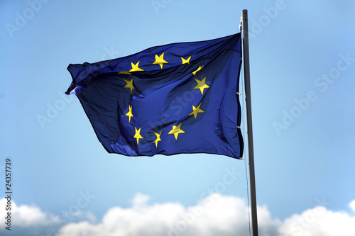 Blue flag of European Union on the cloudy sky