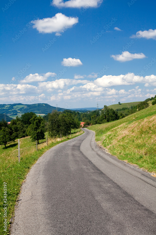 road going through hills and perfect sky