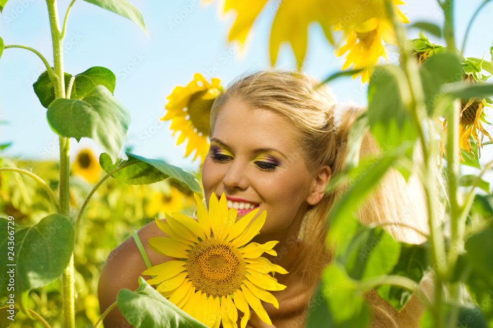 The beautiful girl in the field with sunflowers The beautiful girl in the field with sunflowers