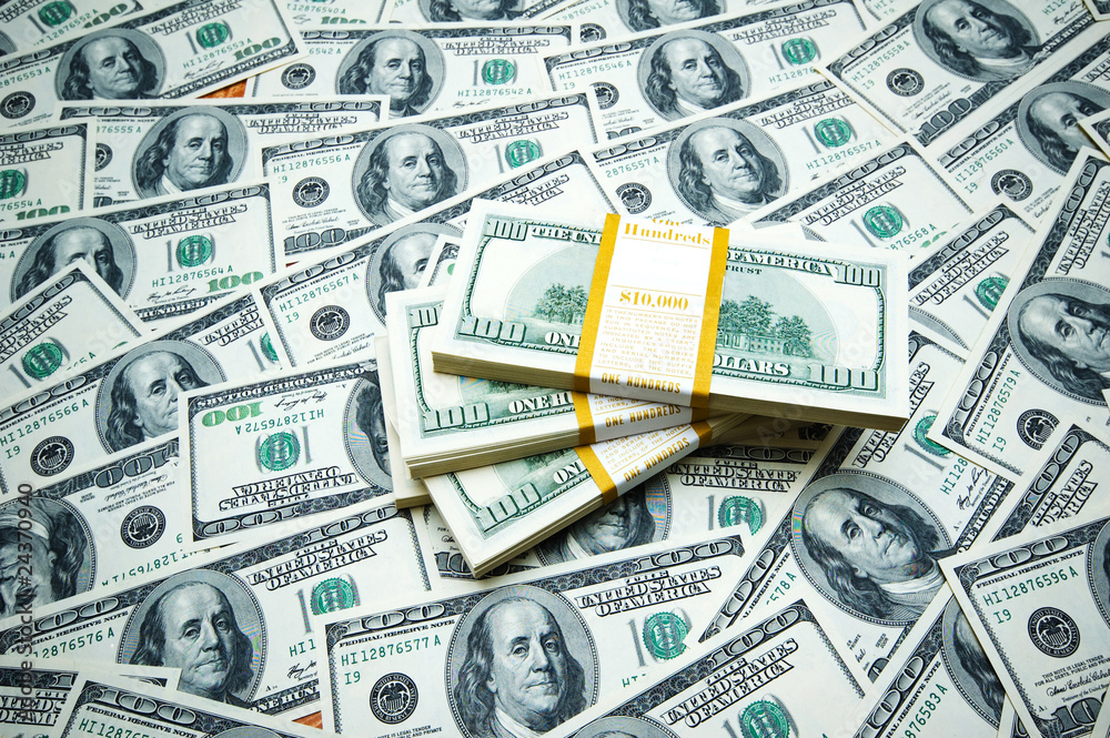 Fototapeta premium Stack of dollars on money background