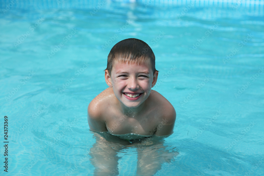 Young Boy with diving Glasses in swimming pool