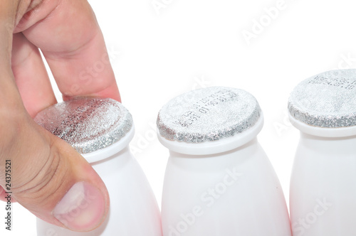men`s hand taking a bottle of milk