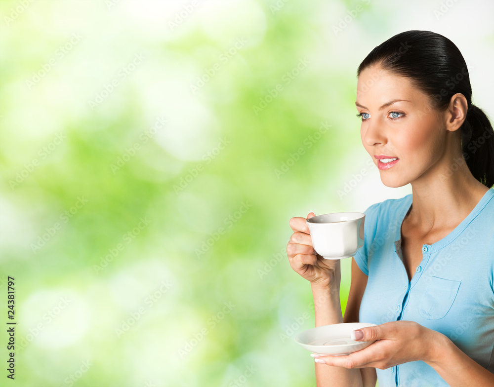 Young happy smiling woman drinking coffee, outdoors Young happy smiling woman drinking coffee, outdoors