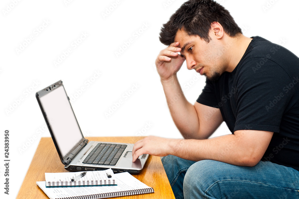 frustrated guy using his laptop isolated on white frustrated guy using his laptop isolated on white
