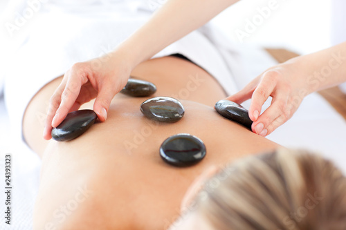 Relaxed woman having a stone therapy