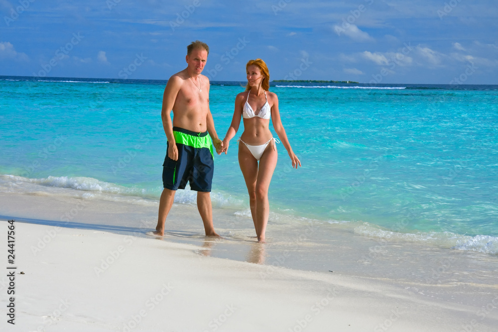 Men and woman at the beach and  ocean, Malfives