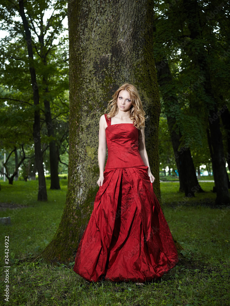 Fototapeta premium beautiful young girl in a red dress