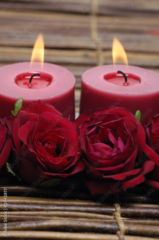 Red rose and candles isolated on mat