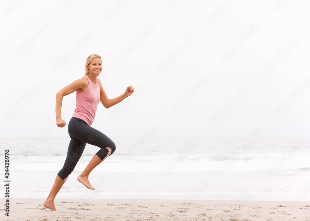 Young Woman Running Along Winter Beach Young Woman Running Along Winter Beach