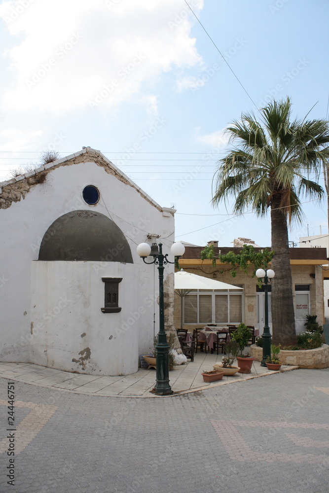 old cretan village view with palm and restaurant