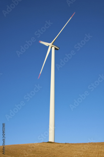 Moving wind turbine with sky background
