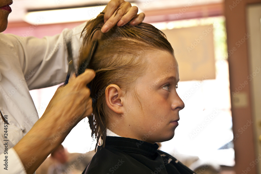 Fototapeta premium young boy at the hairdresser
