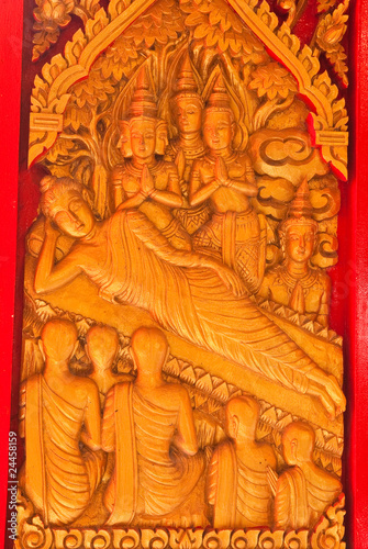 gold buddha statue on wood © suradech