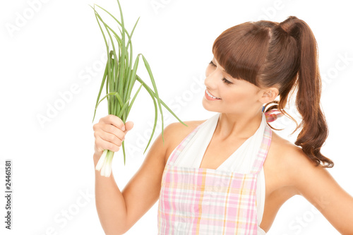 beautiful housewife with spring onions over white