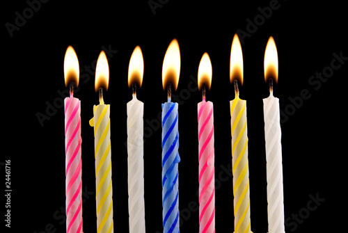 Seven birthday candles on black background
