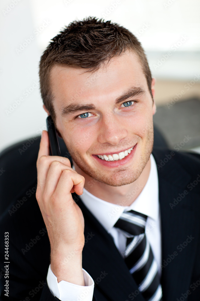 Smiling businessman using mobile phone Smiling businessman using mobile phone